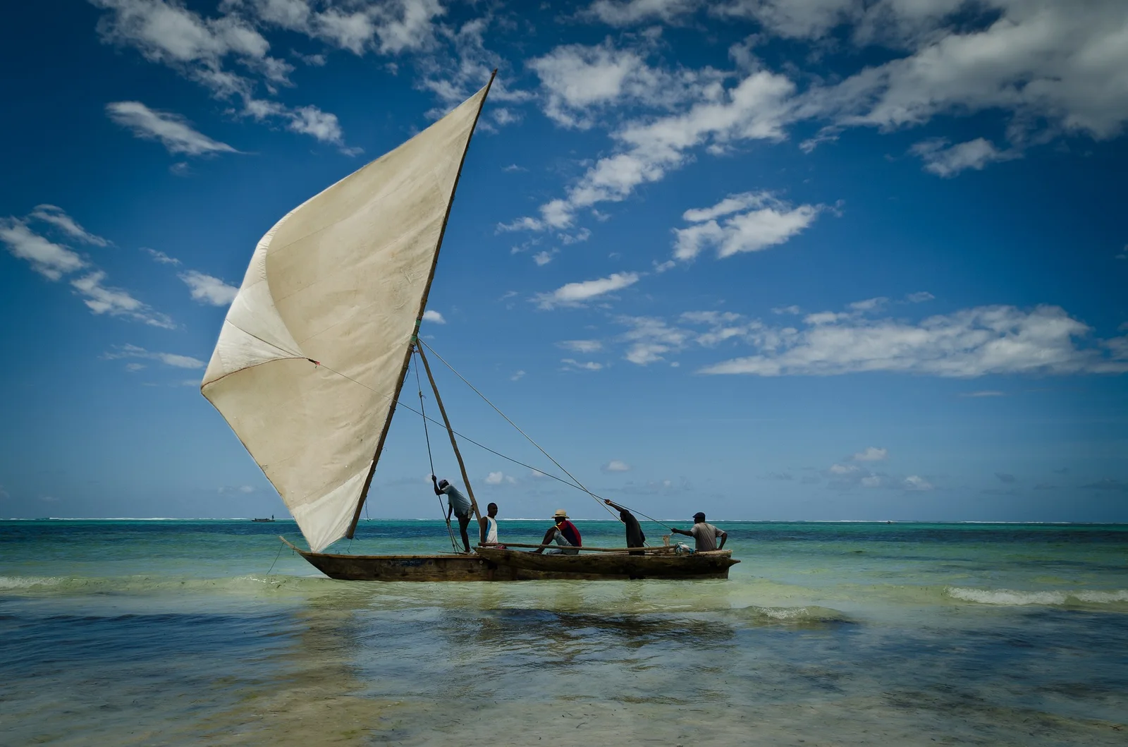 Fishermen sailing a traditional dhow off the Zanzibar coast